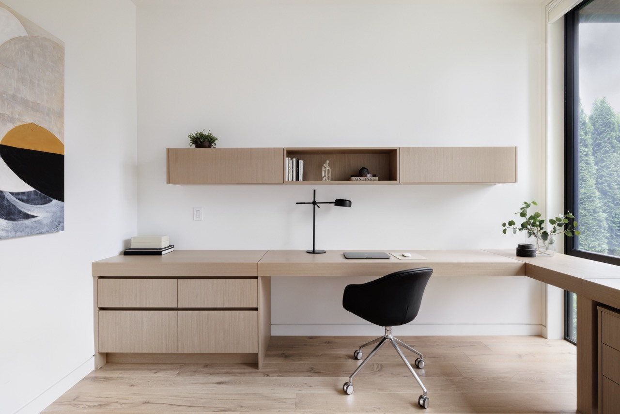 A built-in study area features the consistent light wood millwork and clean lines that characterise the interior design, providing functional workspace within the home’s four bedrooms across three levels