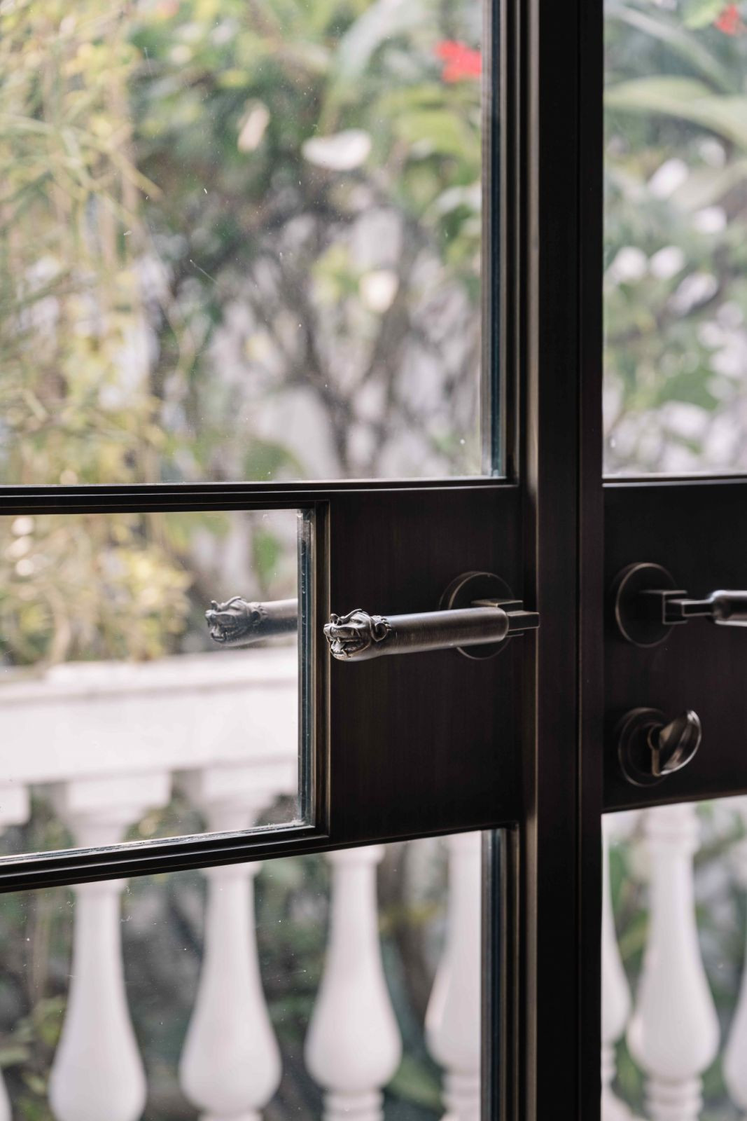Bronze-framed glass doors with handles inspired by 19th-century Indian palanquin posts (Photo: Ishita Sitwala)