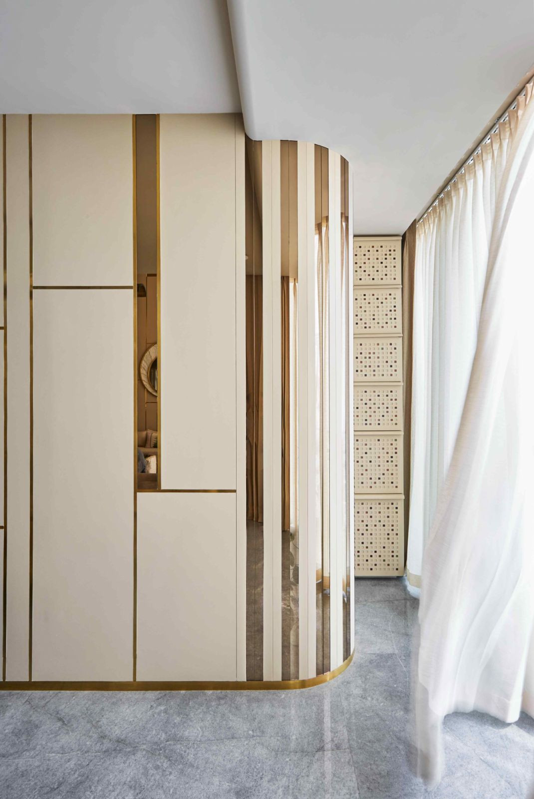 Grid-patterned cabinets with metallic inlays provide concealed storage solutions (Photo: Aspire Studios)