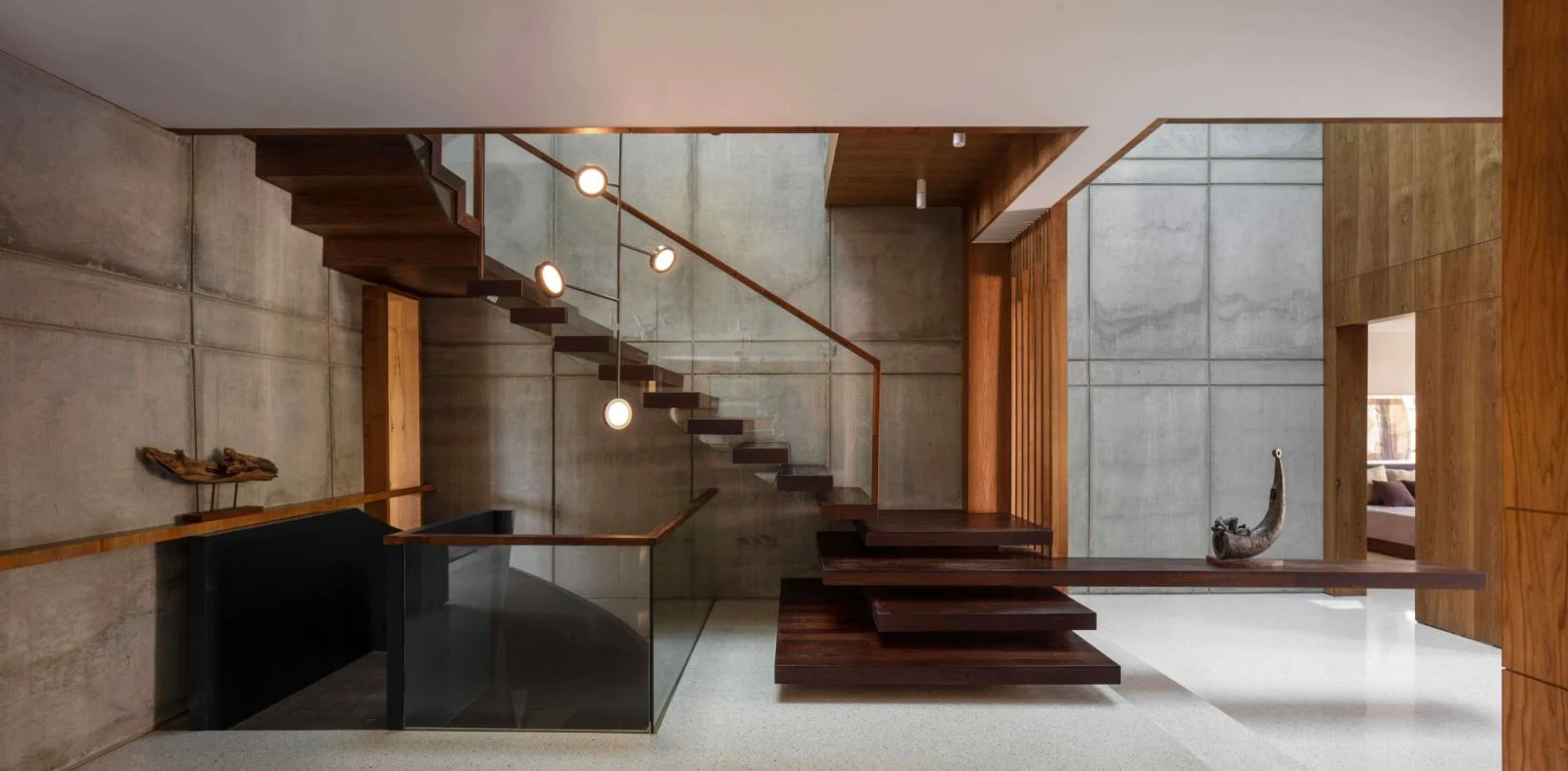 The cantilevered staircase with a “floating” console table in the entrance lobby (Photo: Untitled Design Consultants)