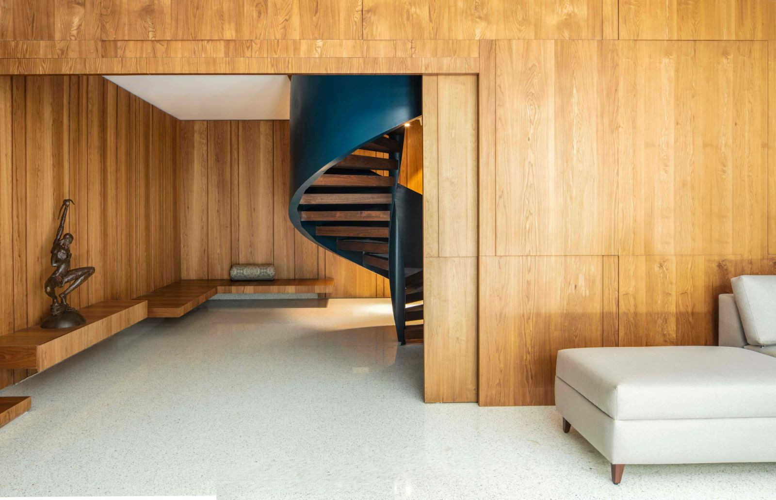 The bold teal spiral staircase that leads into the basement (Photo: Untitled Design Consultants)