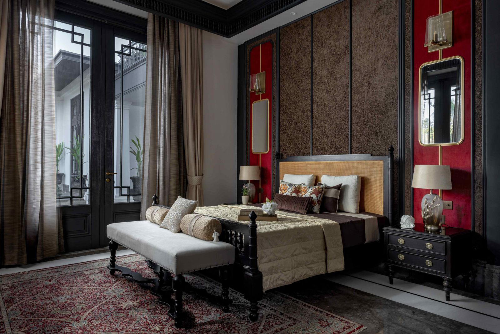 One of the six bedrooms with plush wall panels in rich reds (Photo: Jeetin Sharma)