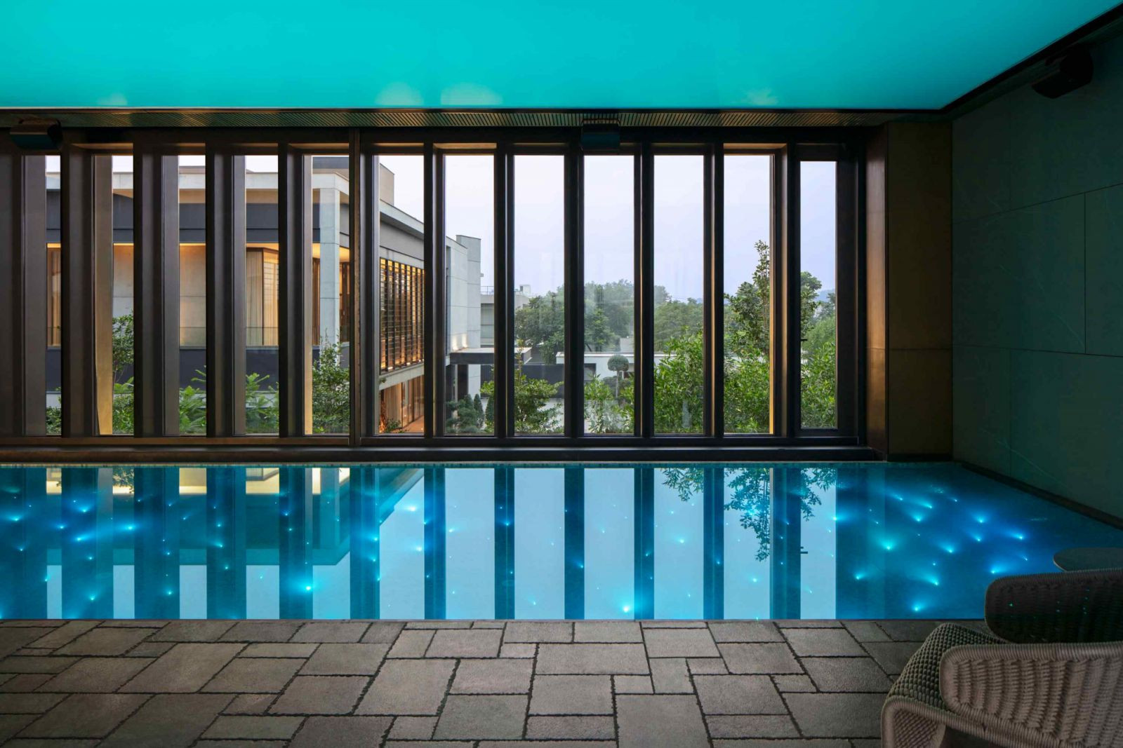 The automated indoor swimming pool serves as both functional amenity and vibrant social hub (Photo: Noughts & Crosses)