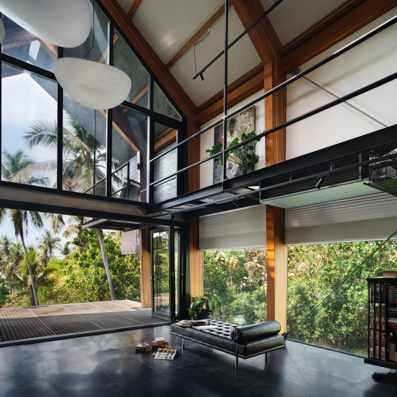 The double-height living area with large glazed openings and a ridge skylight (Photo: Studio Charuau)
