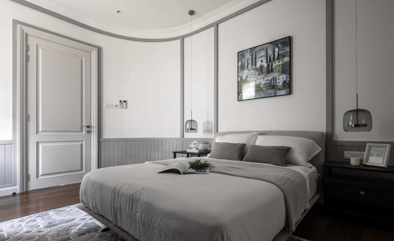 The master bedroom employs decorative grid ceiling details and board-and-batten wainscoting, with neutral linens and warm wood flooring