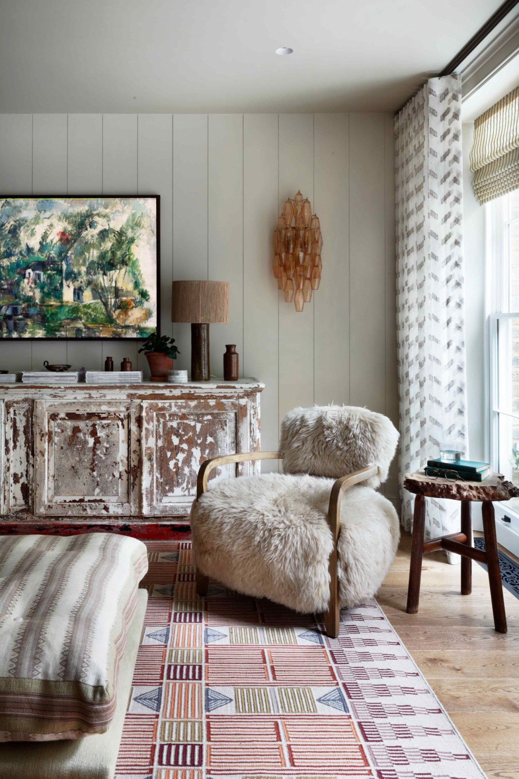 Earth-toned shearling seating and rustic French antiques from a French antique dealer