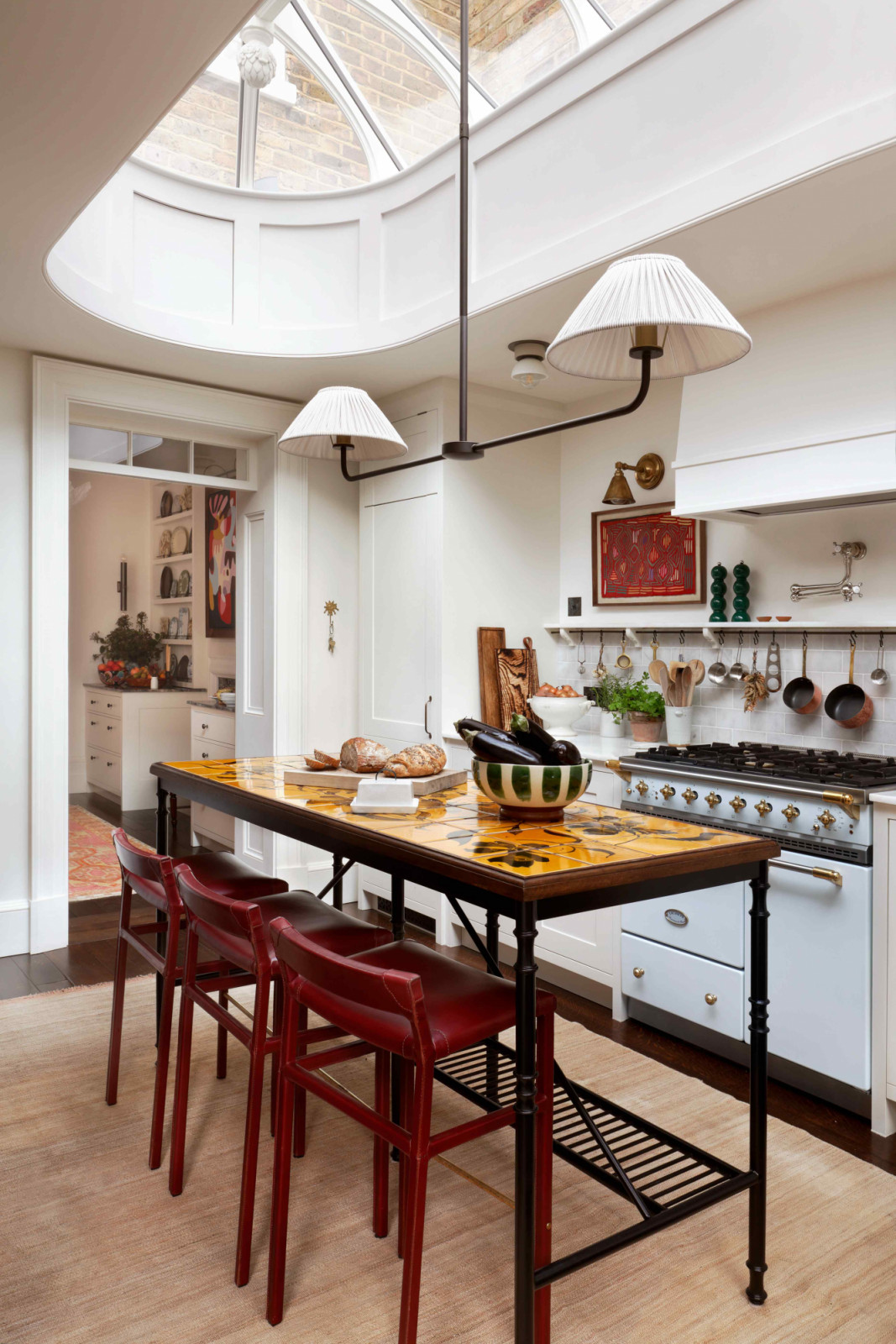 The light-filled extension houses the kitchen, featuring a pill-shaped skylight