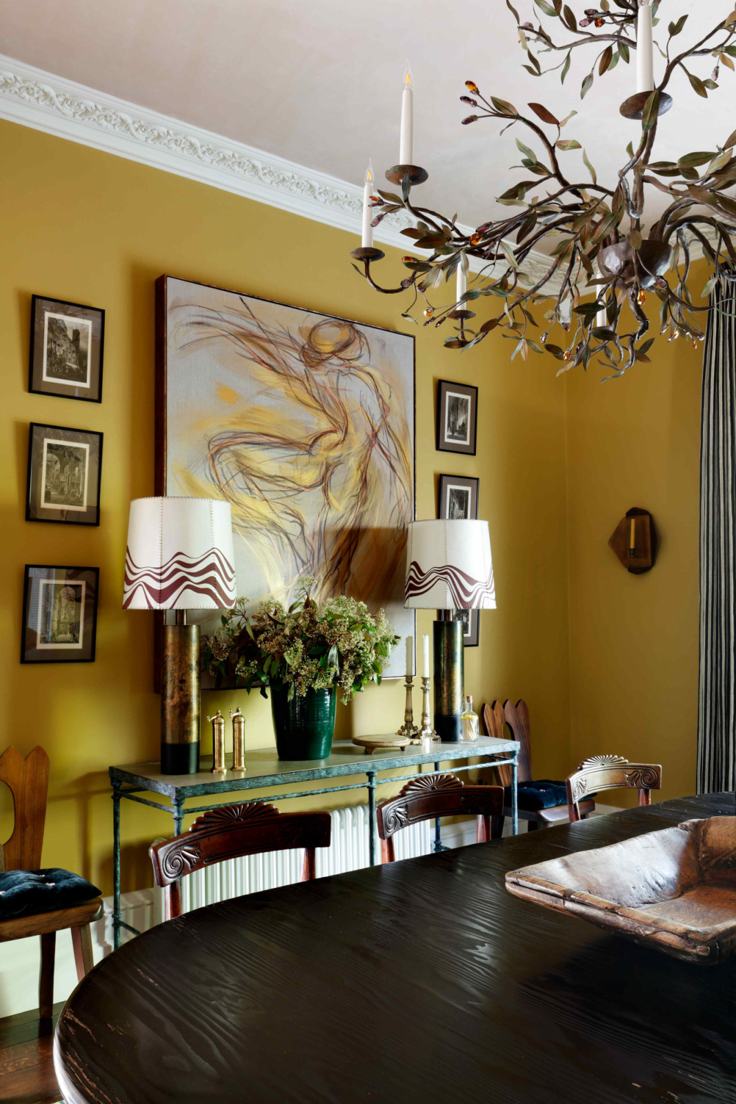 Hand-painted lampshades by Álvaro Picardo decorate the space atop a console table from Chelsea Textiles