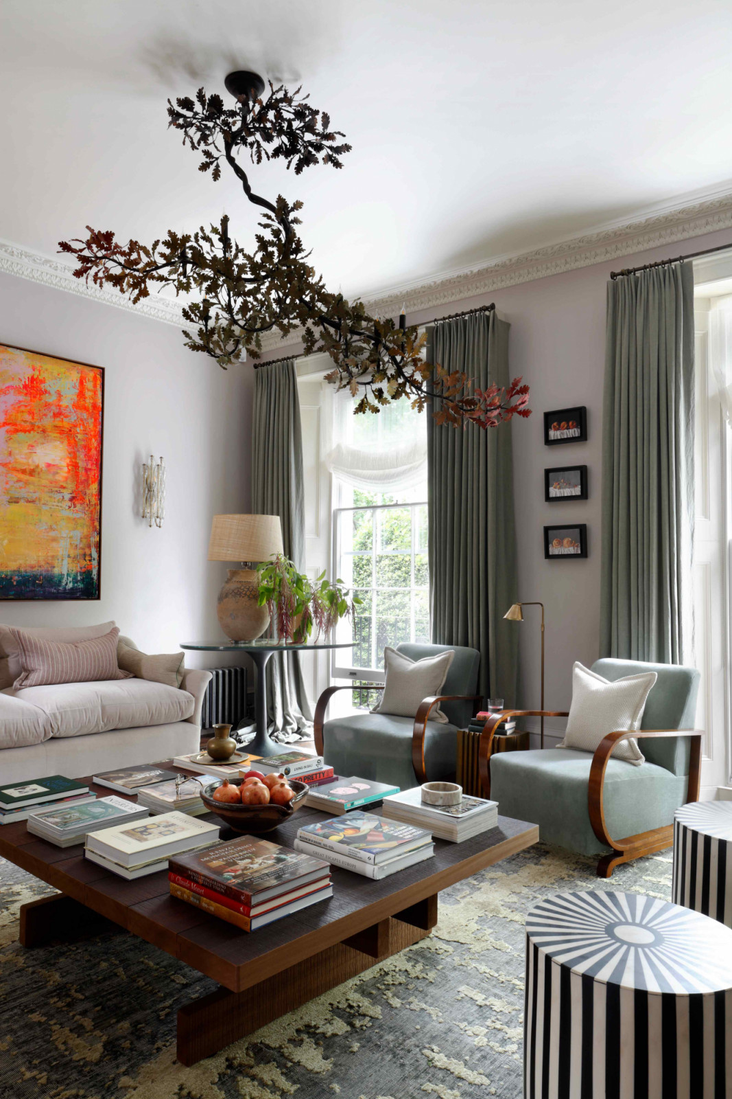 A bespoke oak branch chandelier suspends above a brutalist-inspired coffee table