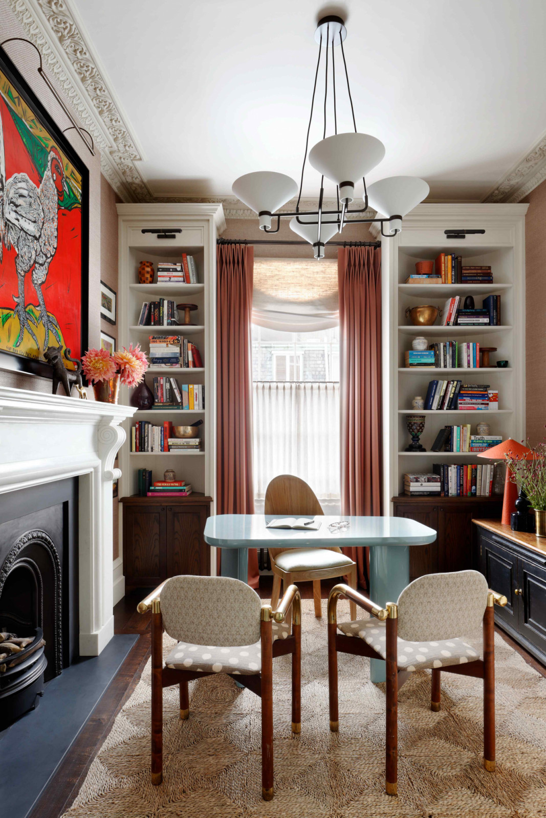An eggshell blue lacquer desk pairs with a Rose Uniacke barrel-back chair in the study