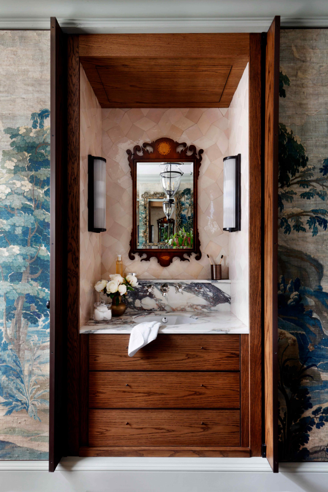 The wood and marble vanity unit sit within the wardrobes with pocket doors