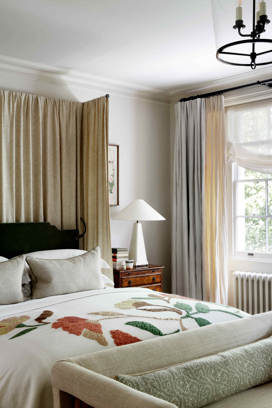 A Robert Langford headboard upholstered in dark green mohair