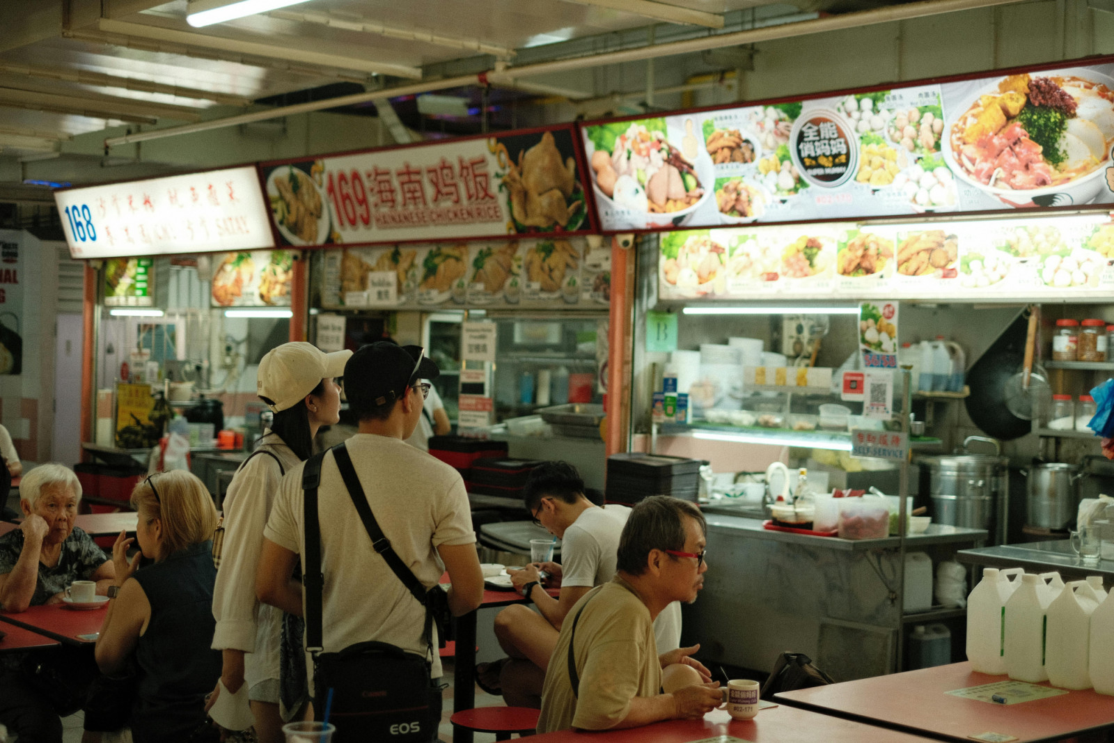 At Singapore’s hawker centres, solo diners enjoy affordable meals alone at communal tables without social pressure.