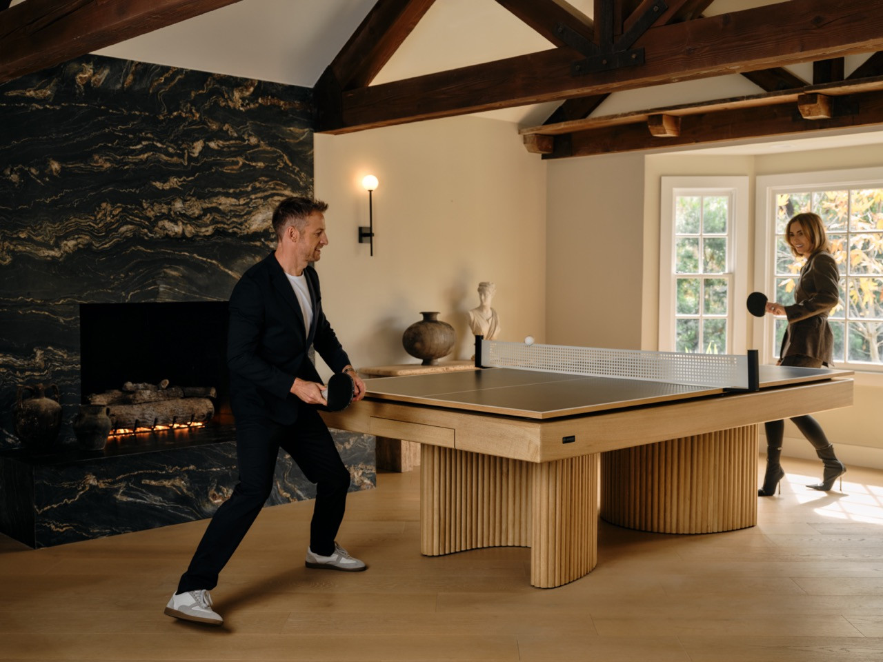 The couple enjoys ping pong on their three-in-one design, demonstrating the “power of play" that’s central to their home life