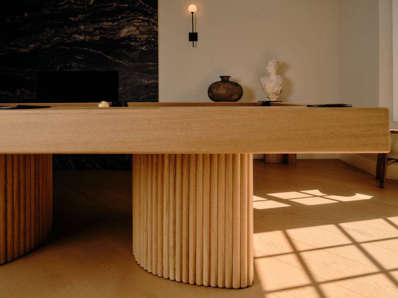Detail of the oak construction showing the reeded C-shaped supports that create Brittny's desired “carved” aesthetic