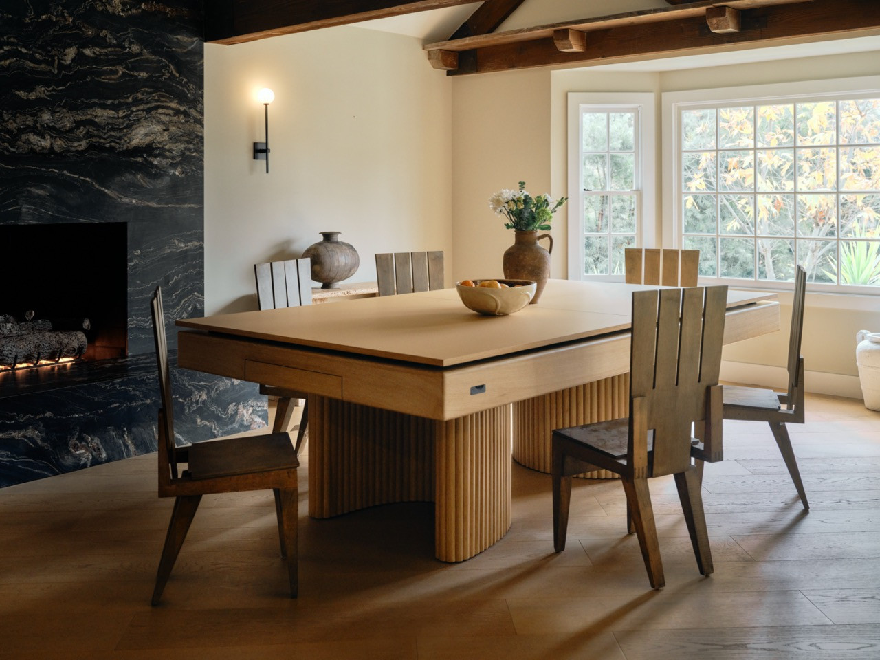 The bespoke 11 Ravens table in dining mode, featuring Doric column-inspired oak supports where the Button family enjoys daily breakfast gatherings