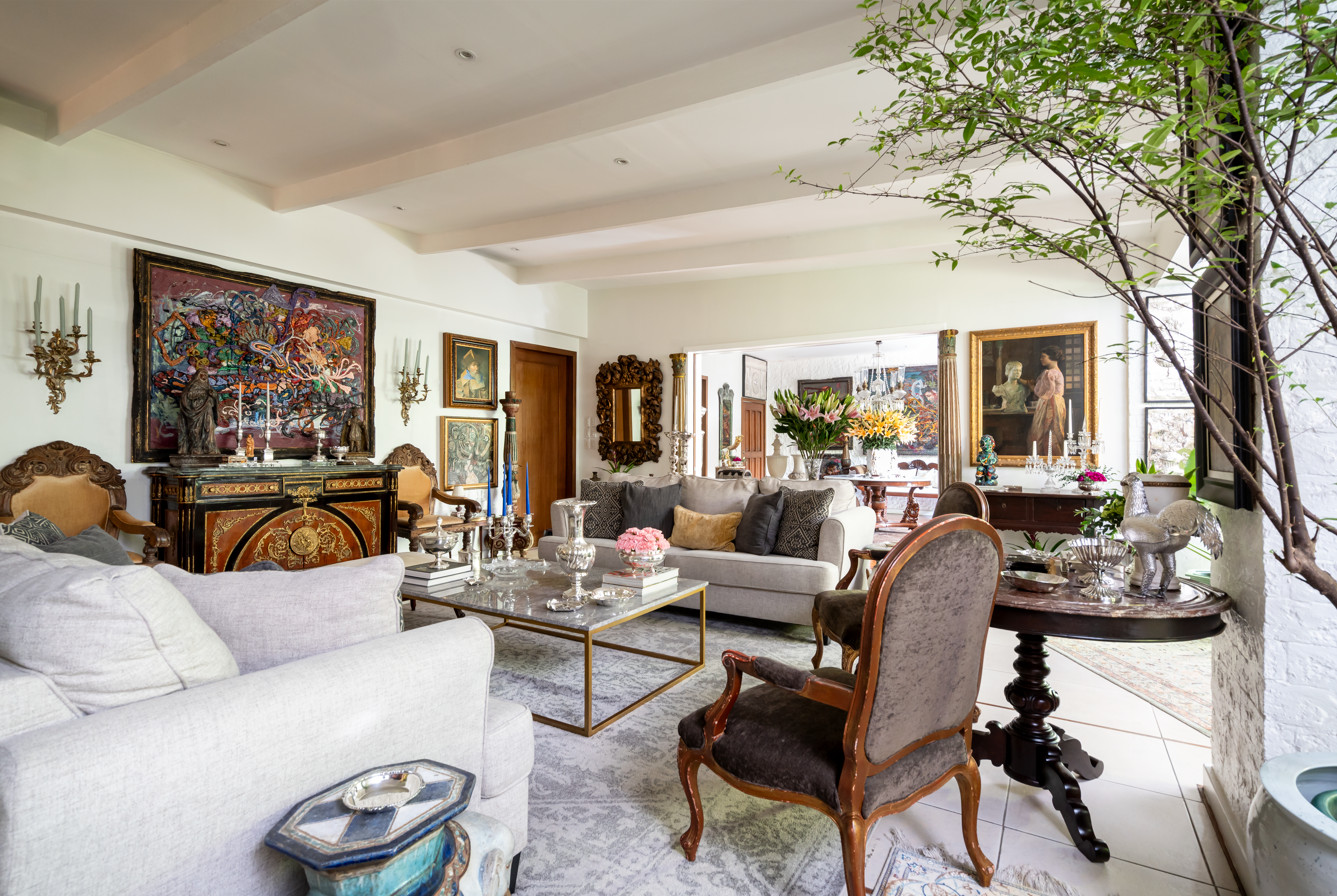 The living room with antique Filipino and European furniture, paired with contemporary works by renowned Filipino artists Arturo Luz, Jigger Cruz, Brian Uhing, Manuel Ocampo and Romulo Galicano (Photo: Toto Labrador)