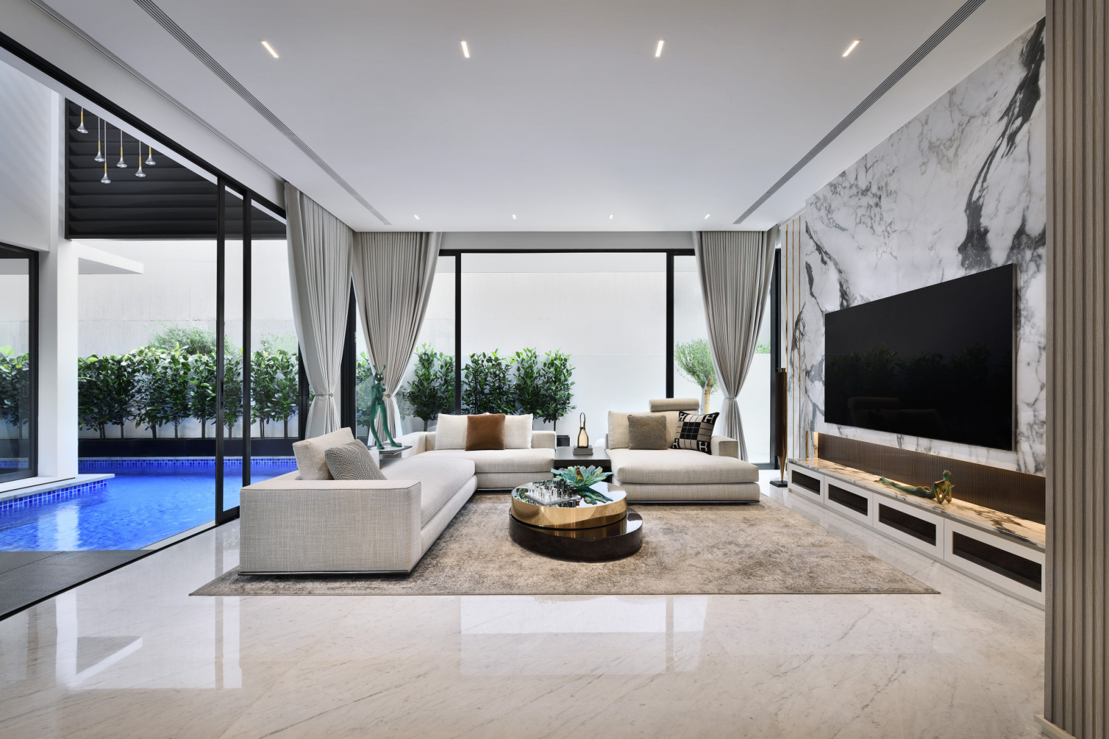 The luxurious living room is flooded with natural light