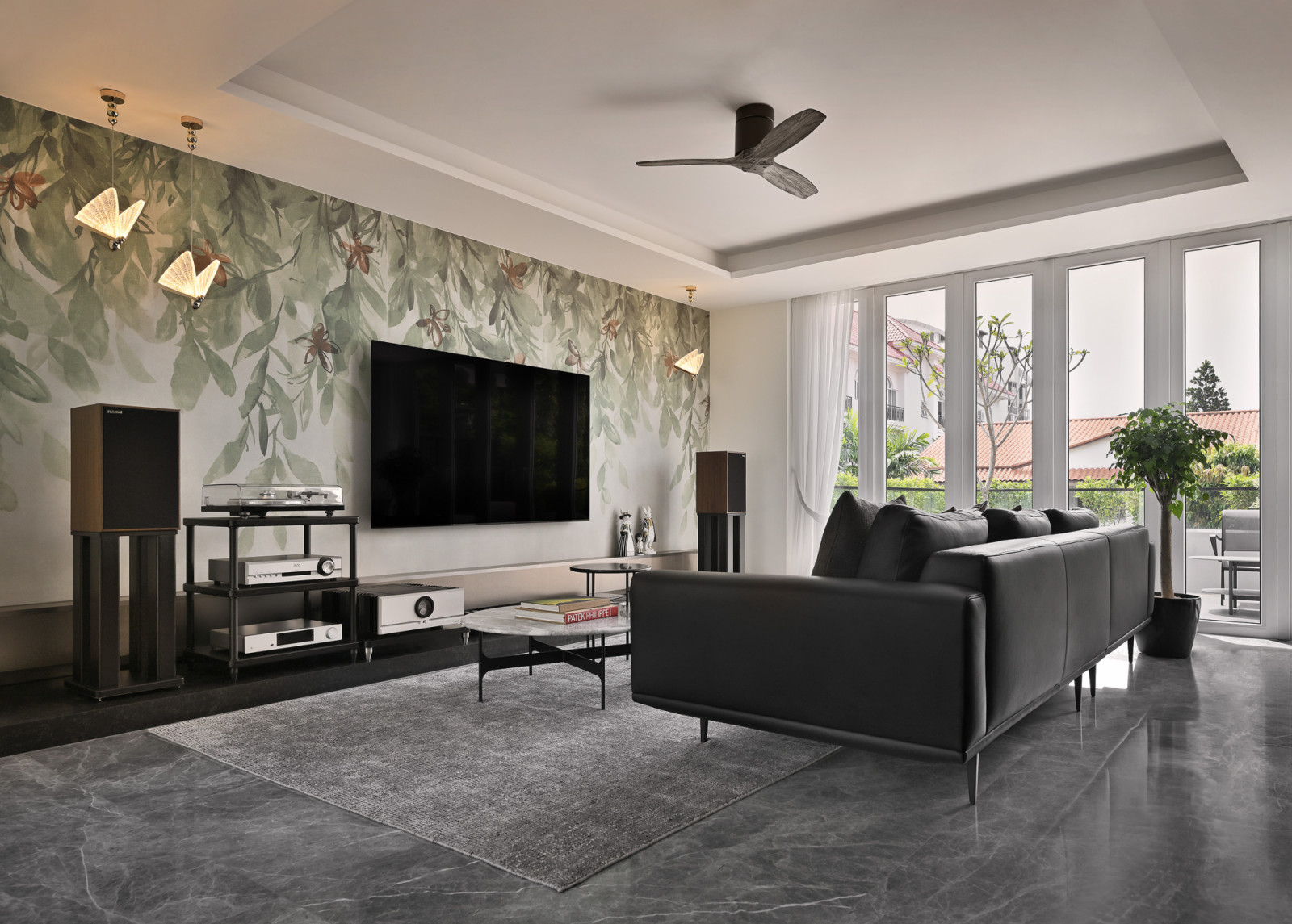 Large-format Hafary tiles are arranged along the living room wall to create a dreamy botanical feature