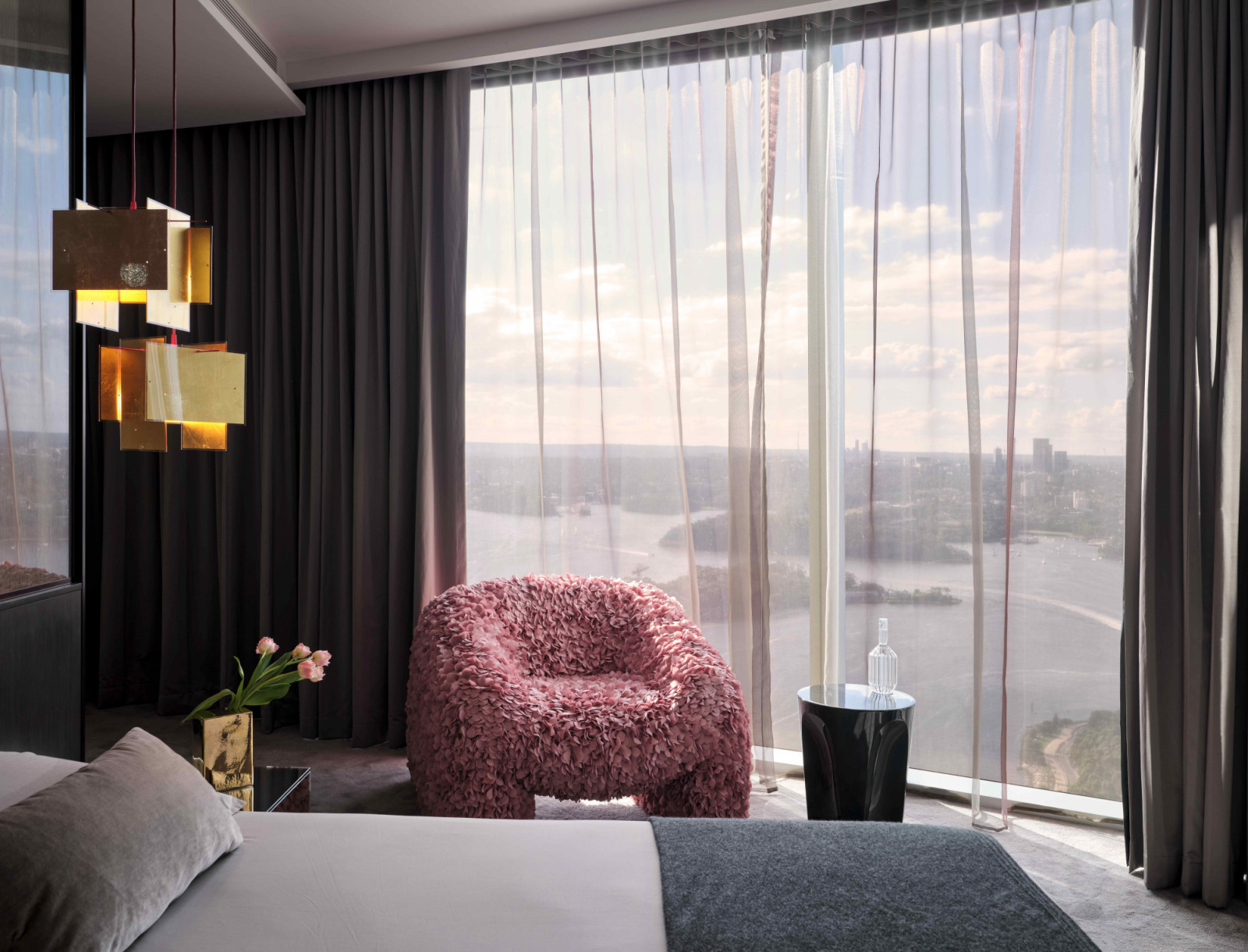 The Moooi Hortensia armchair in the bedroom with views of Darling Harbour