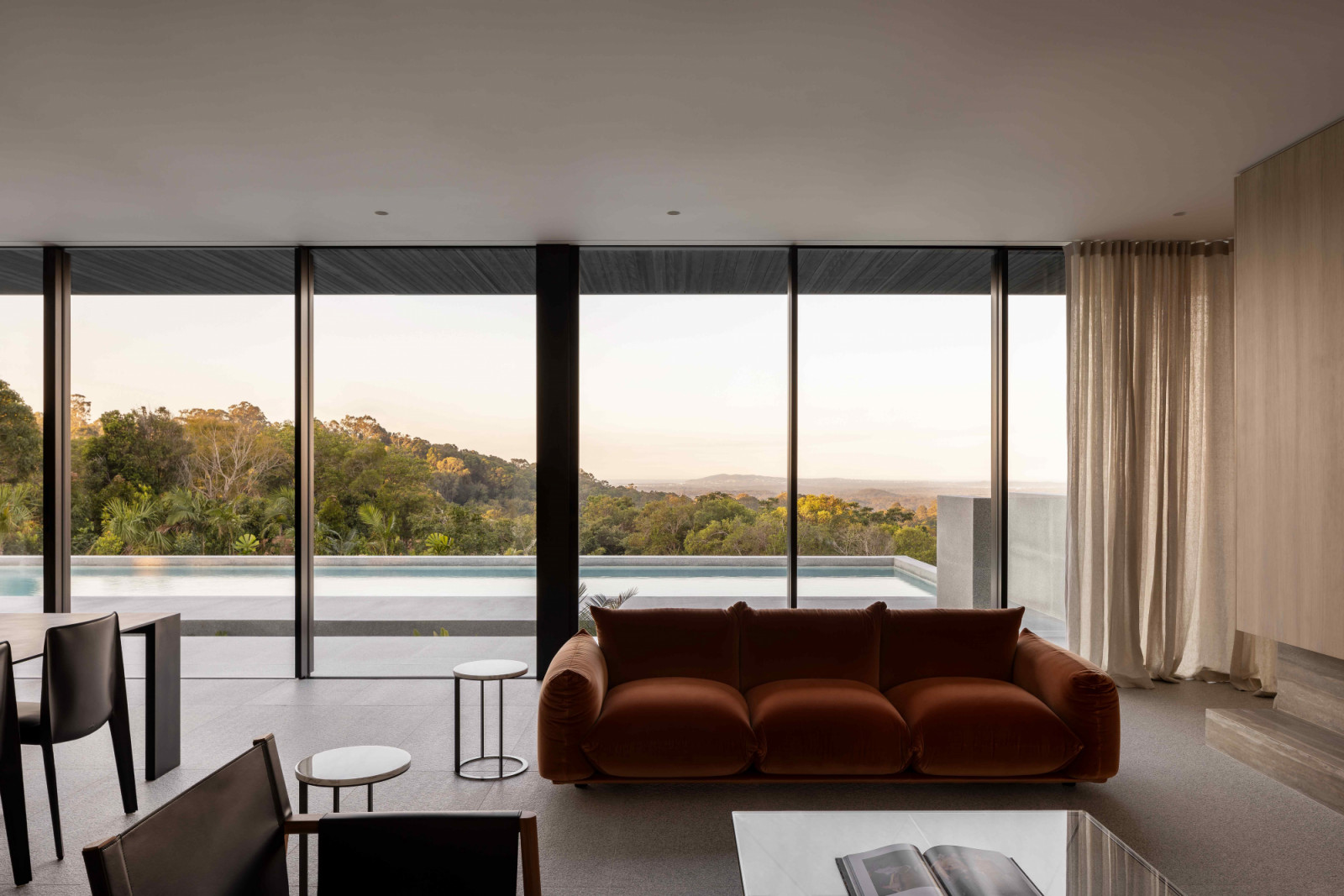 The Marenco sofa by Arflex in an earthy rust velvet correlates with the surrounding greenery