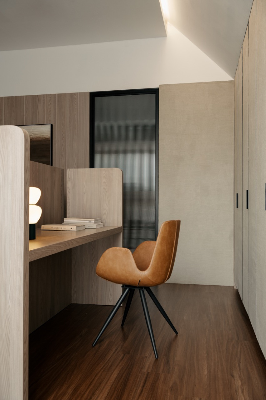 A compact study nook with custom orange upholstered seating and integrated desk storage was designed to accommodate the family's daily routines