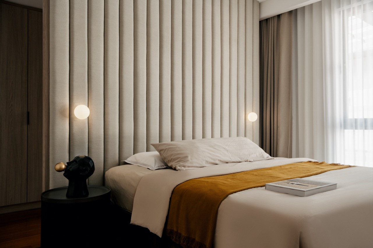 Another bedroom showcases textured fabric wall treatment with custom lighting integrated into the architectural millwork