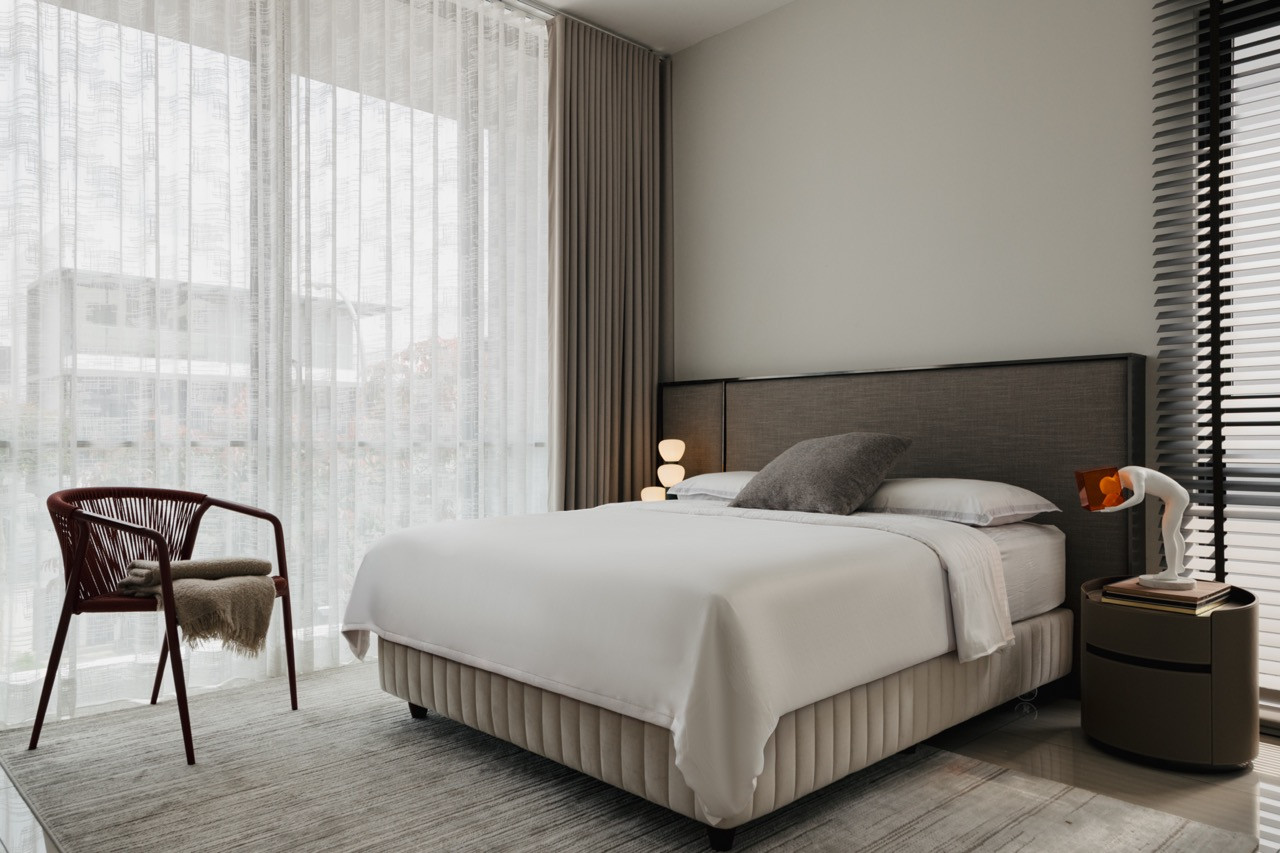 A bedroom with contemporary furnishings and traditional Malaysian residential proportions create comfortable spaces for extended family visits