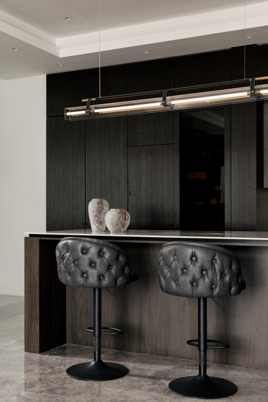 The main kitchen island becomes the social heart of the multi-generational compound