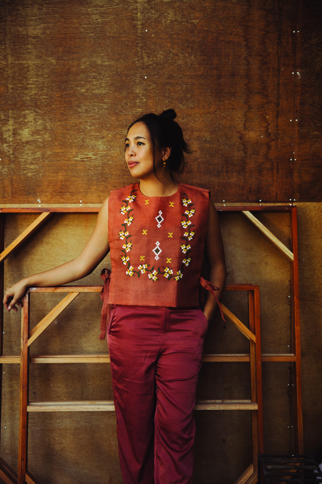 Vanessa Gaston wearing the Bulak Barong Bib in rust from Niño Franco by Mindanaoan designer Wilson Limon