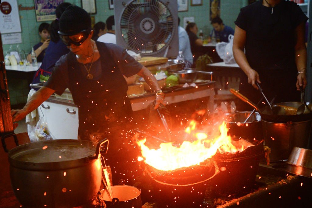 Jay Fai cooks in kitchen on coal powered stoves at street eatery was recognised with a one-star Michelin guide, in Bangkok, Thailand, 09 December 2017. A 70-year-old Thai street food seller who makes wok-fired dishes has been awarded a Michelin star at the launch of Bangkoks first guide. In a city famous for street food, a roadside restaurant in Bangkok with plastic tables and simple but sumptuous fare has earned one of the dining scene's highest honors: a Michelin star. (Photo by Anusak Laowilas/NurPhoto