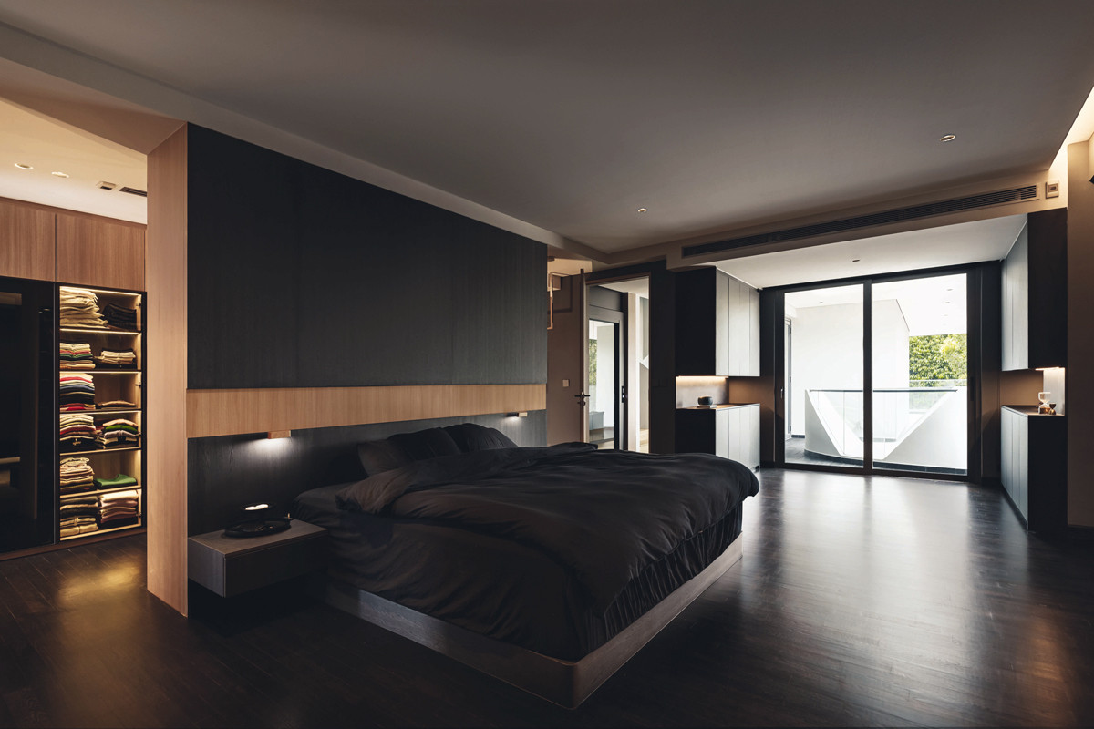 This moody bedroom exudes a calm, restful ambience