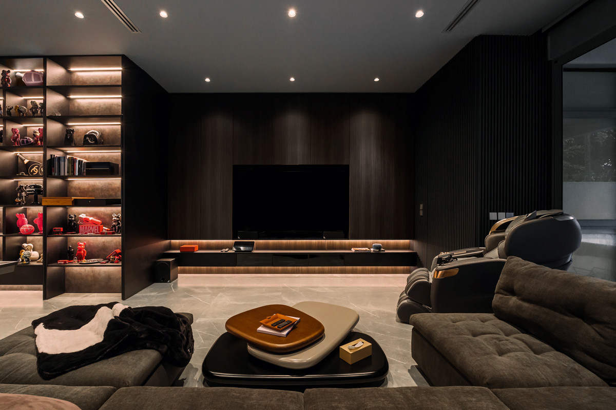 The cocooning entertainment room gets a visual lift from pops of vibrant colour