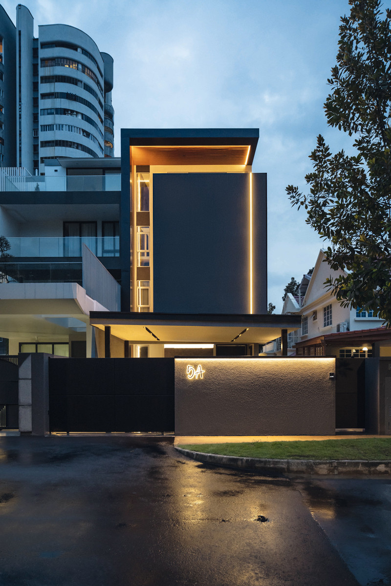 The semi-detached home’s discreet facade openings emit a soft glow at dusk
