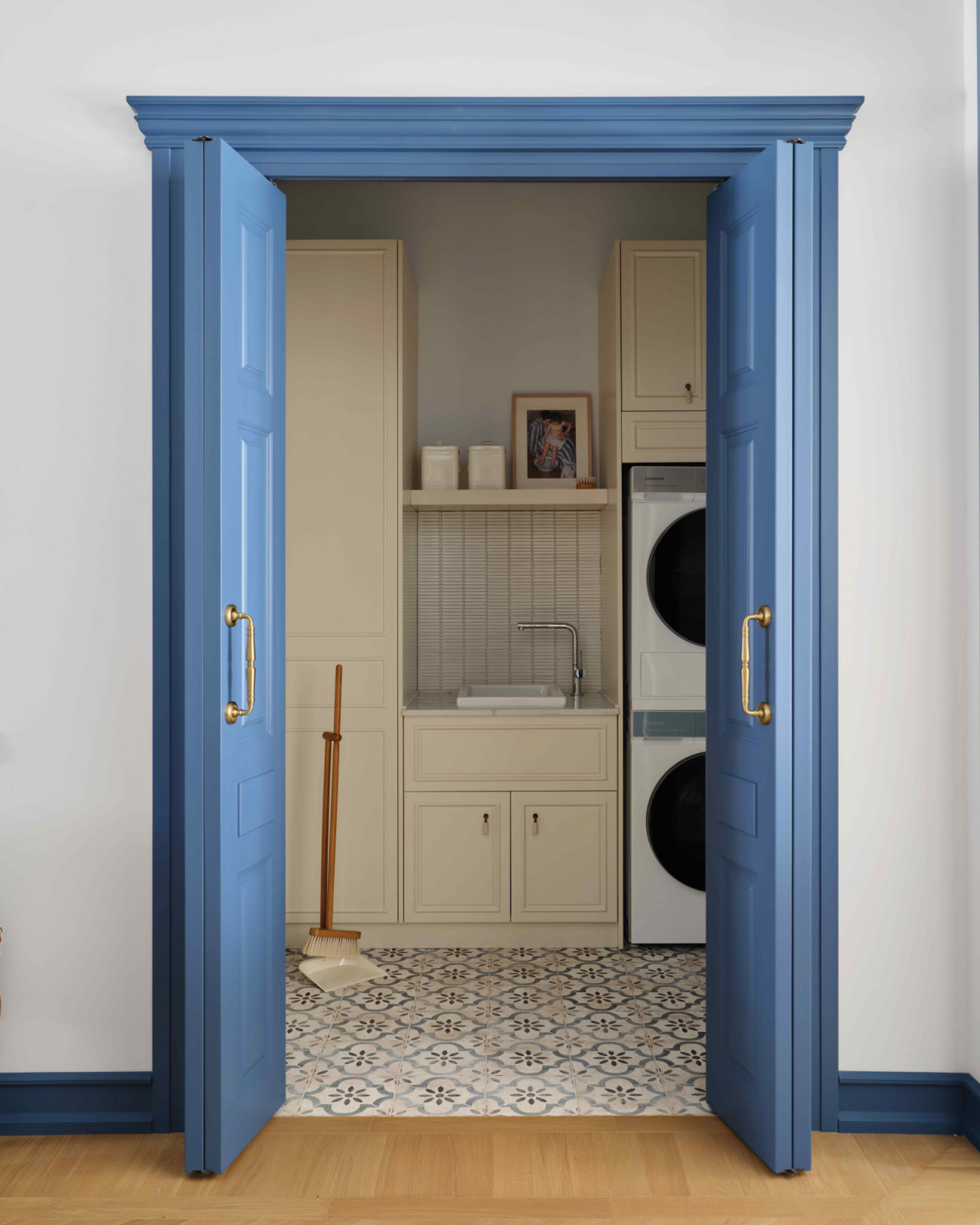 Parisian-inspired blue doors open into the laundry room
