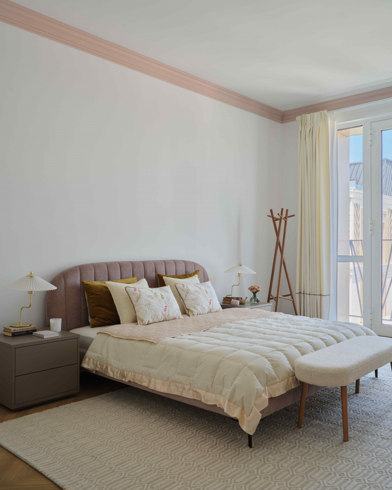 The bed features a felt panel by Saule Madieva and contemporary Scandinavian furnishing