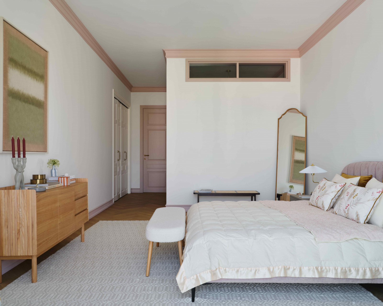 The master bedroom embraces soft, powdery tones of dusty pink, creamy beige, and grey olive
