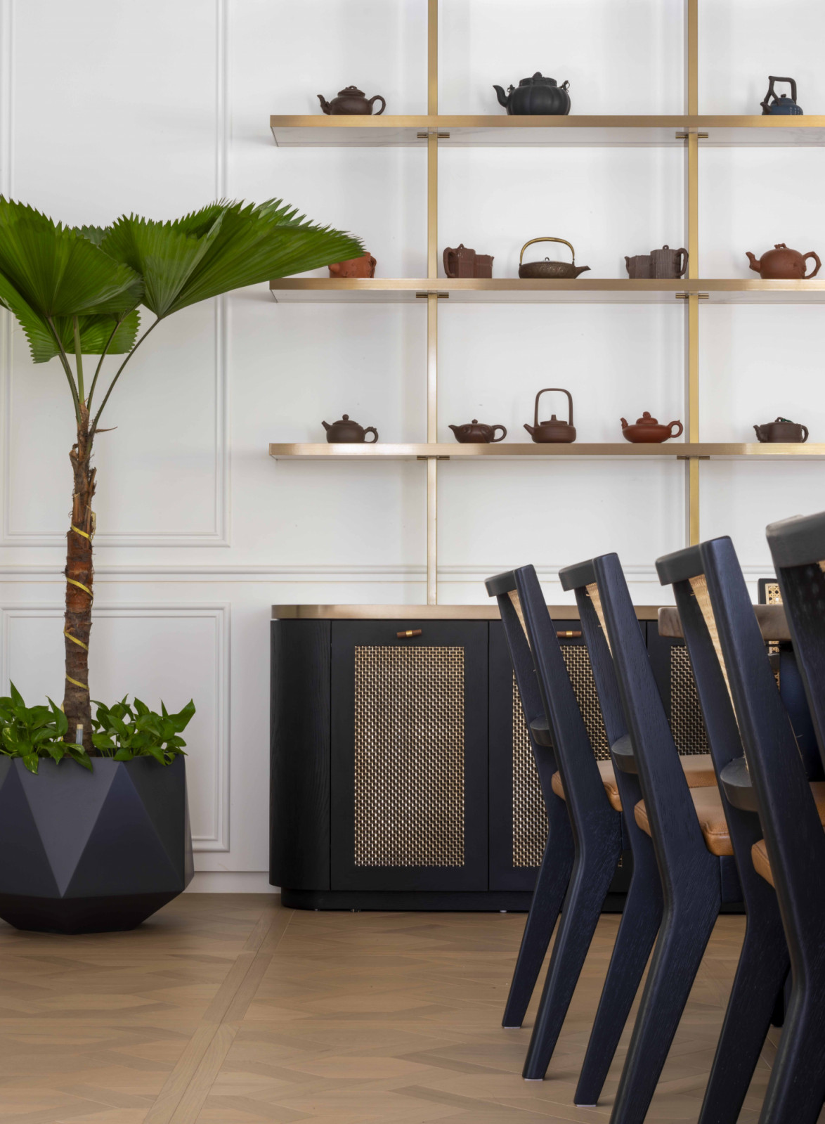 Display shelves showcasing a curated collection of teapots hint at the client’s passion for tea