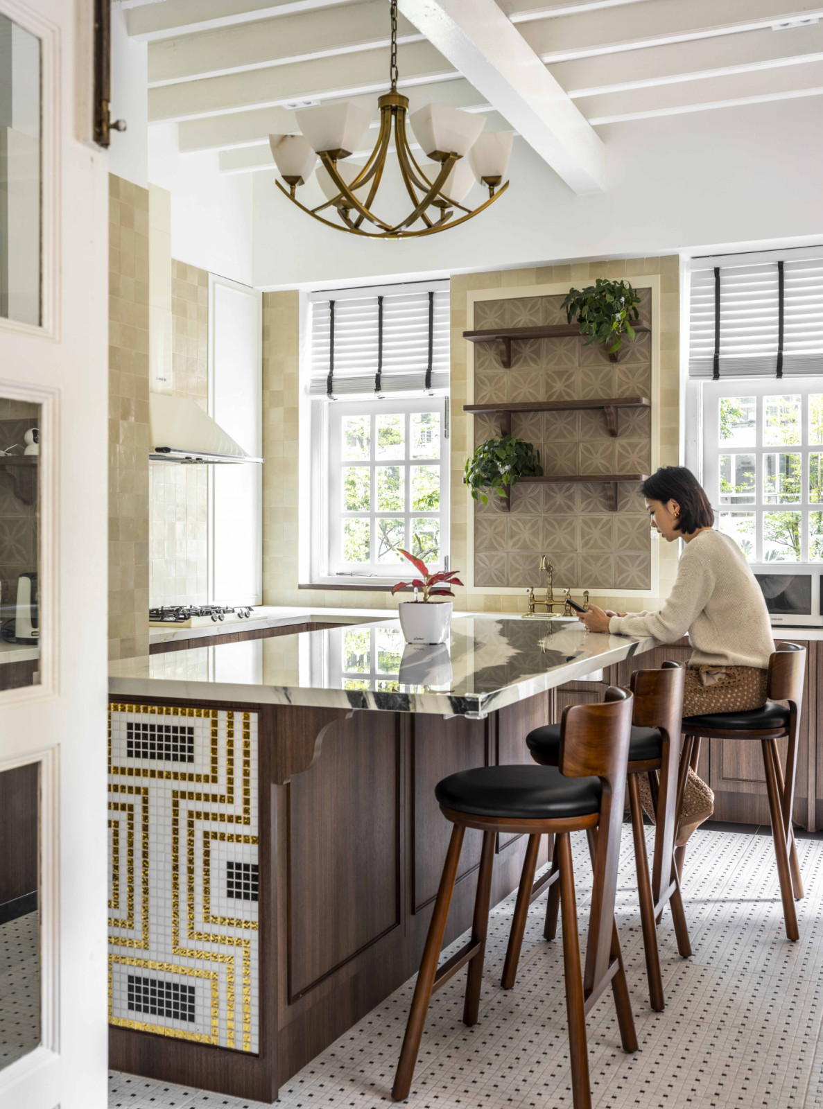The lady of the house enjoys a quiet moment in the kitchen, where vintage motifs and modern comforts meet