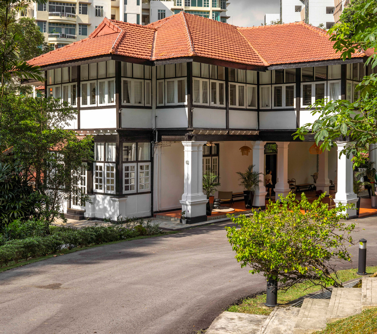 A view of the heritage bungalow’s driveway, framed by mature trees