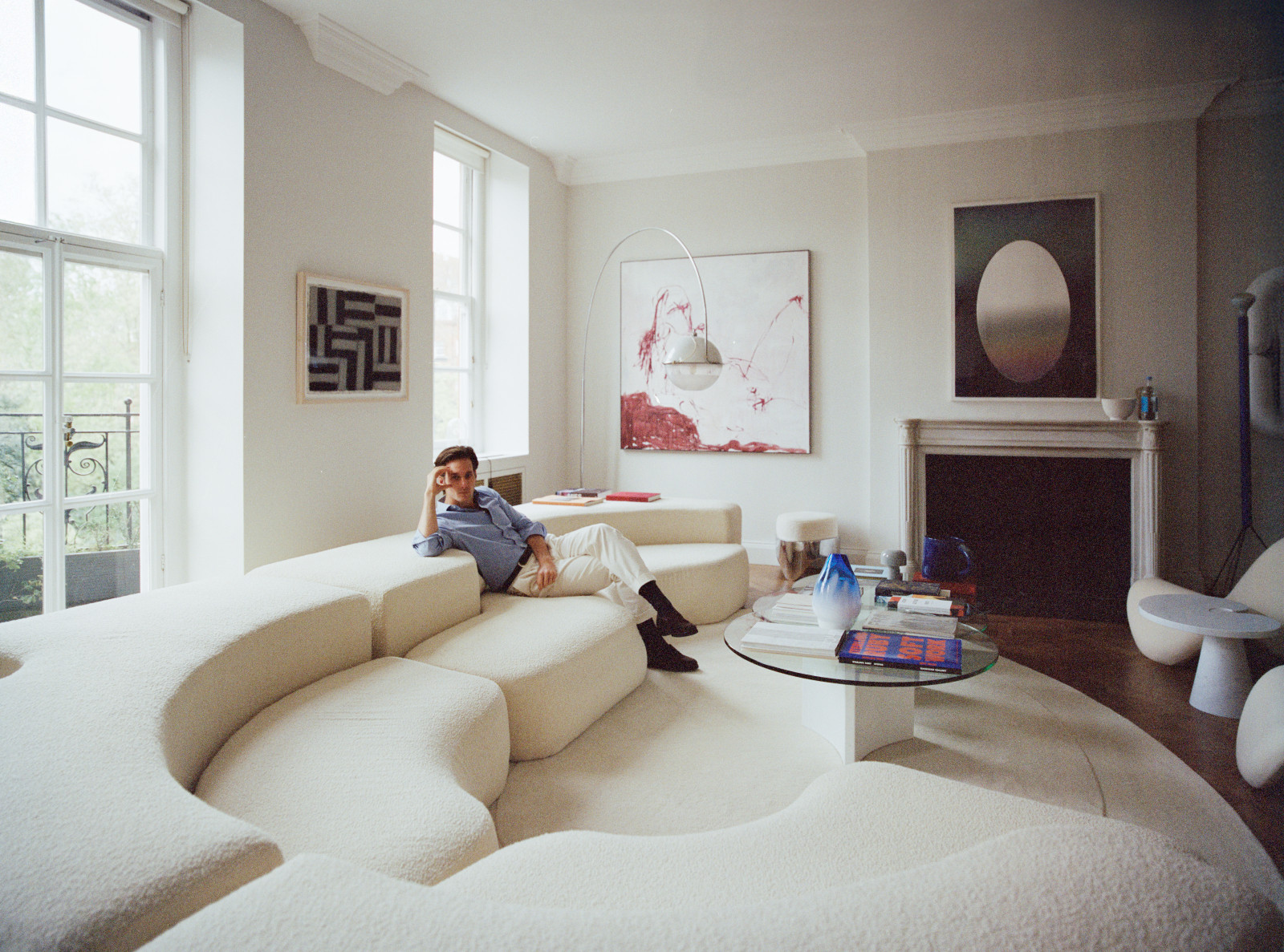 Lawrence Van Hagen in the living room of his London home, where works by Tracey Emin, Sean Scully and Larry Bell are set among sculptural seating and mid-century lighting