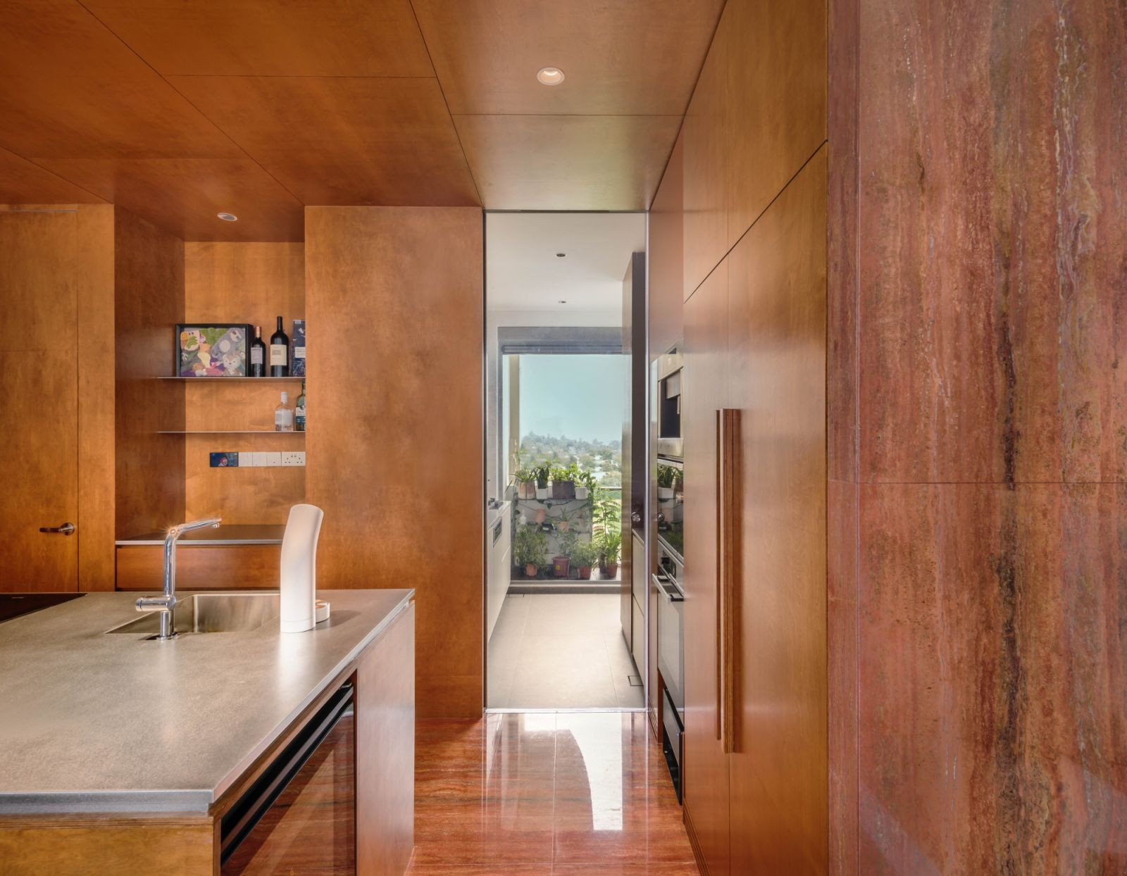 The dry kitchen contrasts cool metal accents against the surrounding wooden tones