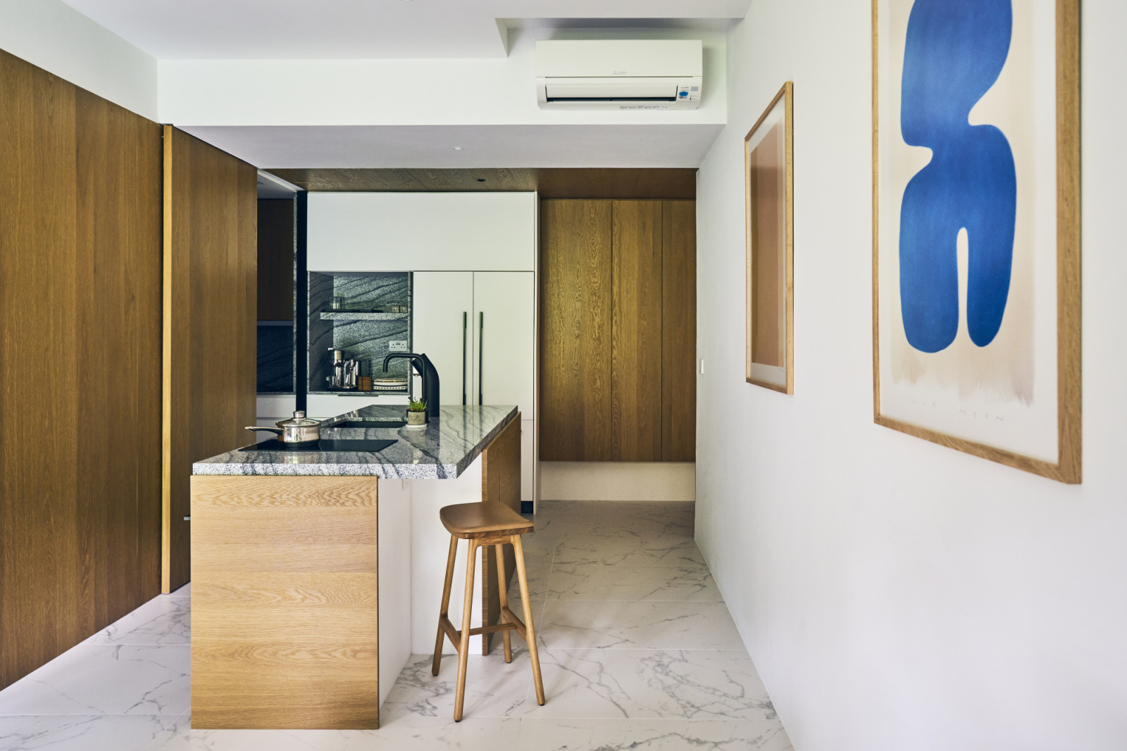 The original kitchen, previously an enclosed space by the entrance, was opened up to form a welcoming dry kitchen with an island