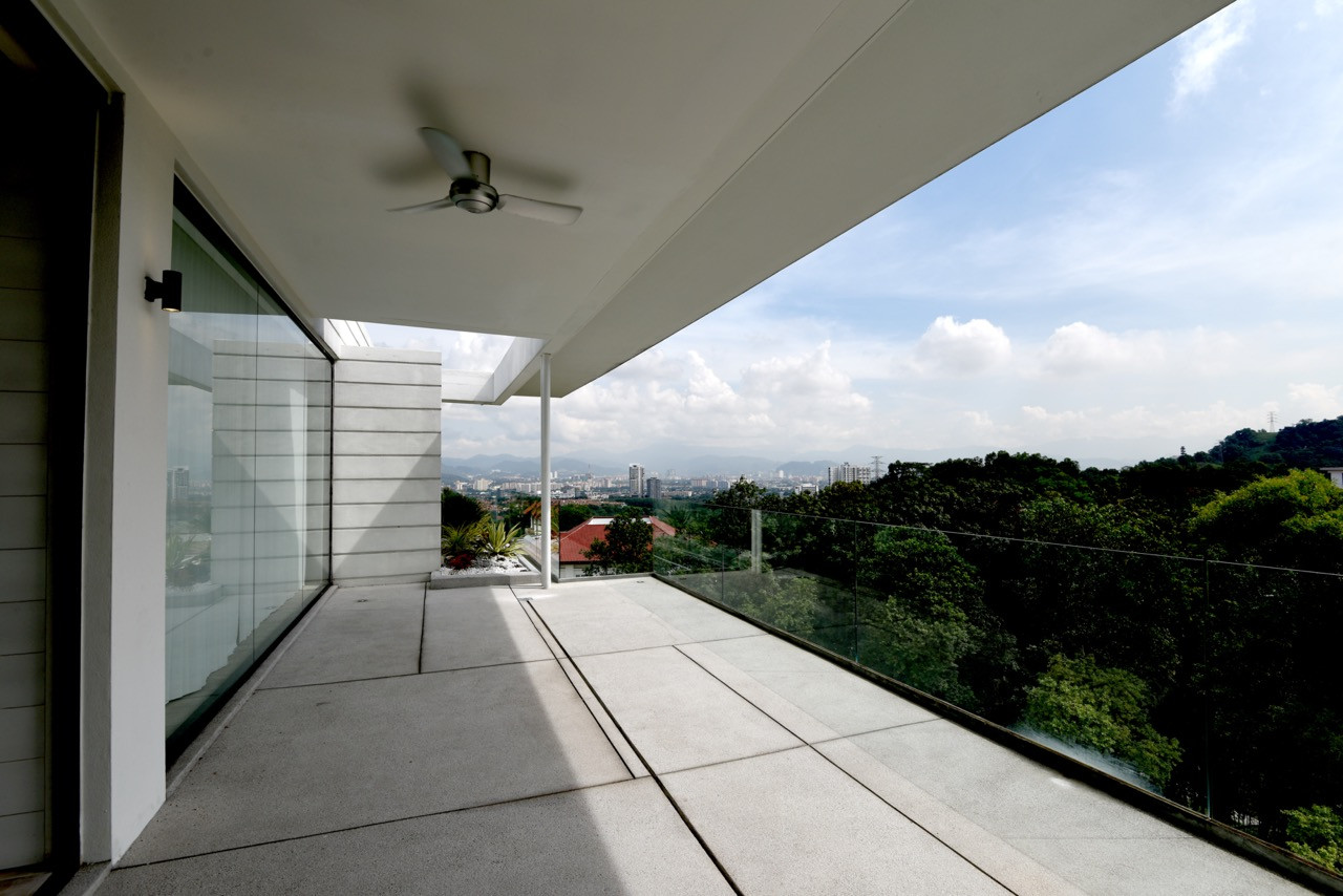 A multi-level interior view shows the sculptural marble staircase ascending through glazed volumes, with timber ceilings providing acoustic softening in double-height spaces
