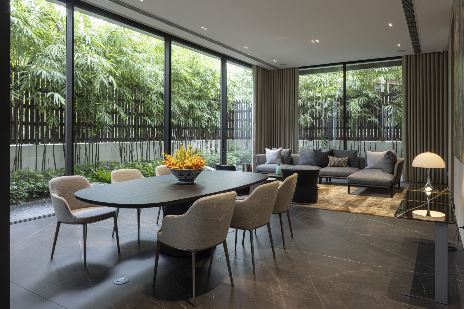 The dining area features the Orama minimal-frame sliding doors enable fluid transitions