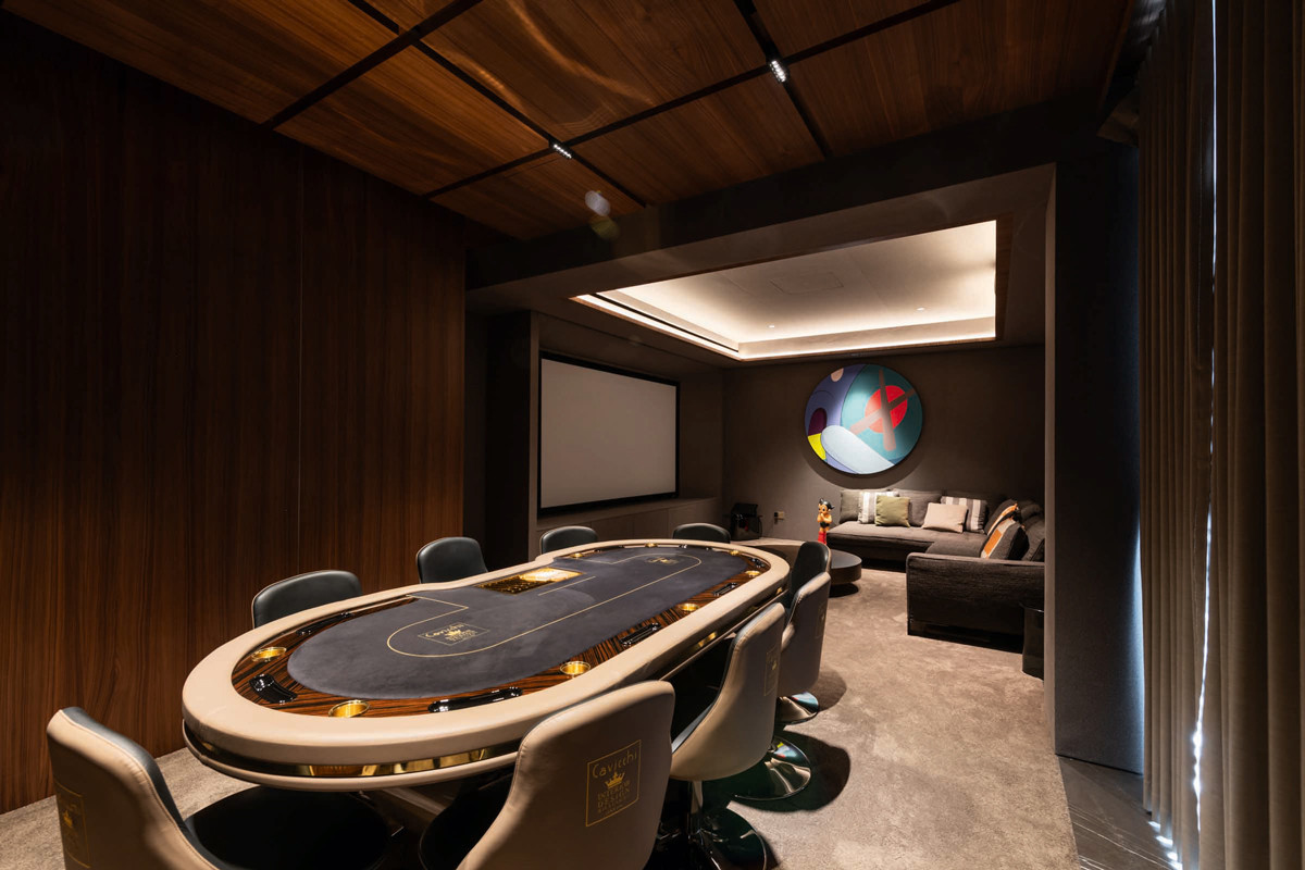 This playful entertainment room by Architology Interiors is anchored by a sleek poker table