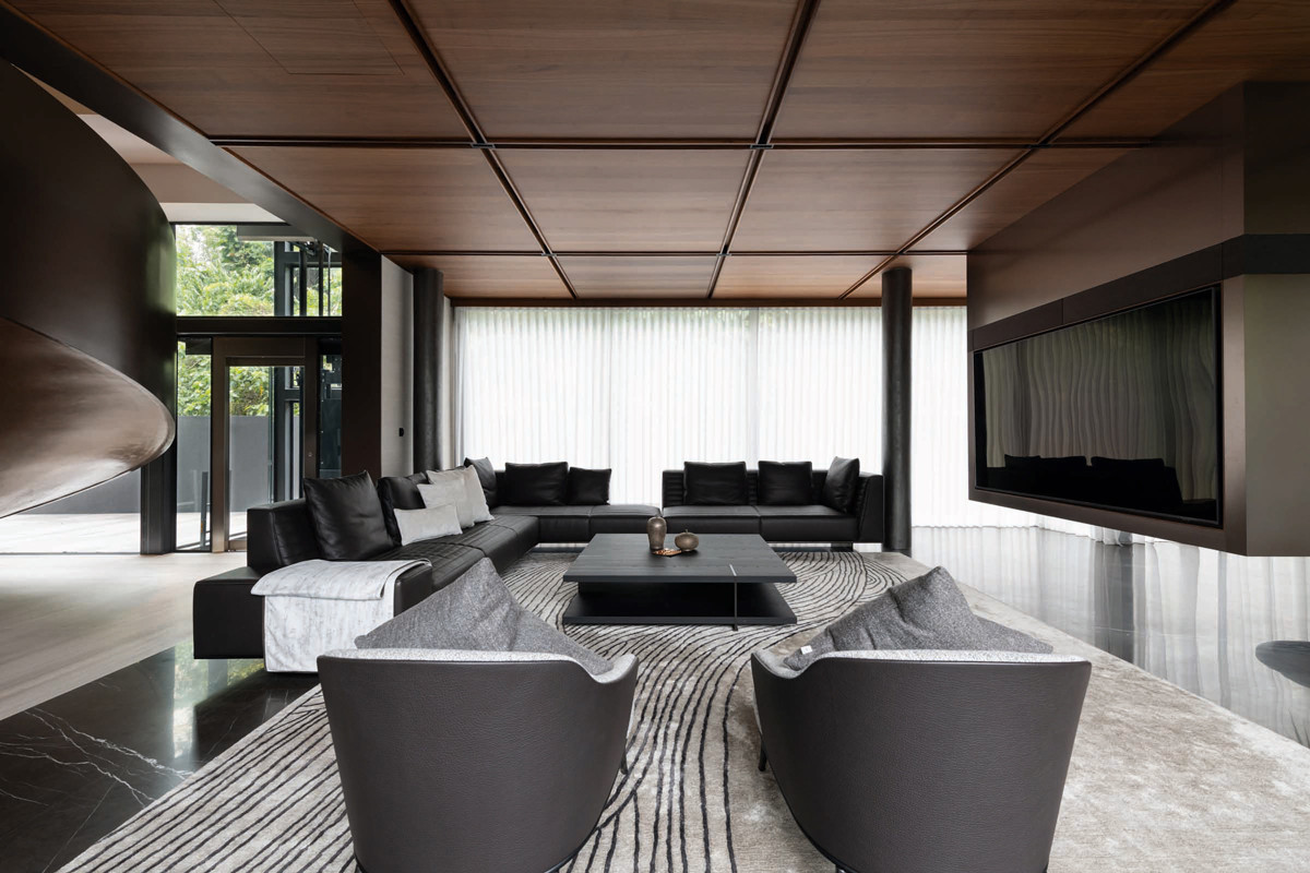 The living room’s custom floating metal TV wall makes quite an impression
