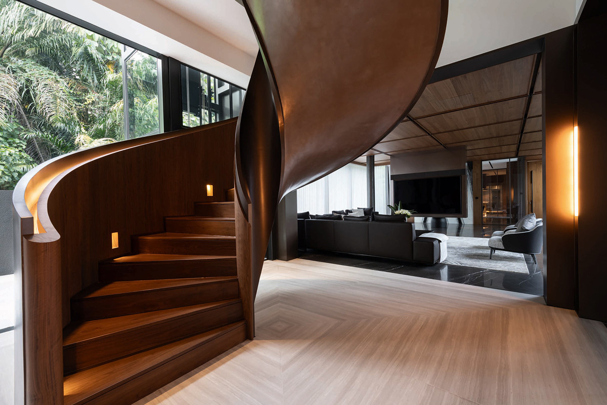 A sinuous spiral staircase softens the minimalist living room