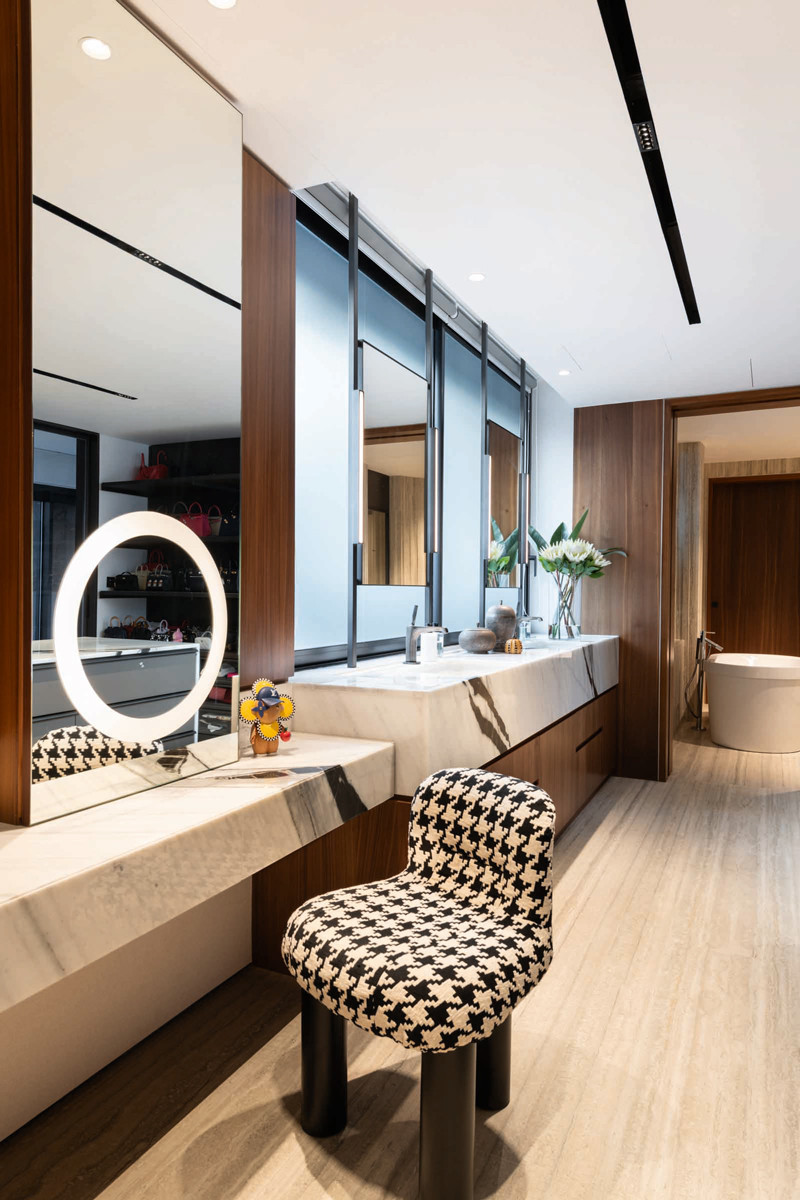 A long vanity area with a smart mirror makes getting ready for the day exciting