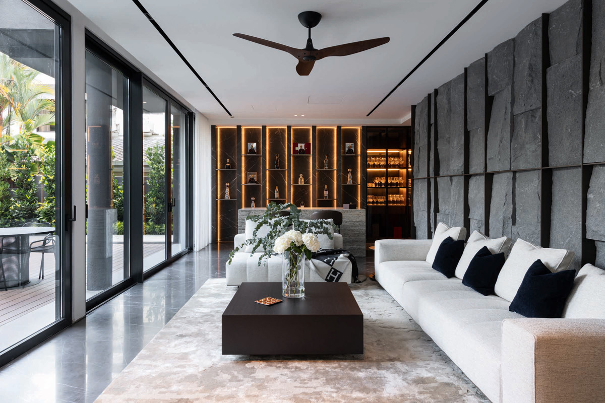 An LED-lit display and stone-clad feature wall add visual rhythm inside this home by Architology Interiors